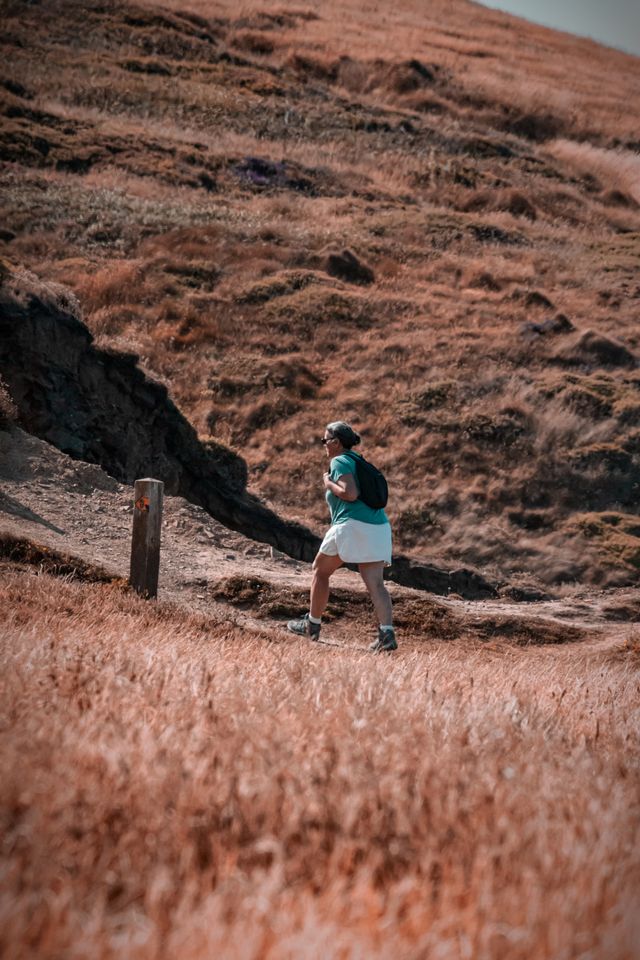 A person treks through the scenic hills of Hartland